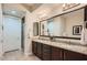 Modern bathroom with double sinks, granite countertops, and a separate glass-enclosed shower at 27000 N Alma School Pkwy # 1033, Scottsdale, AZ 85262