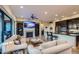 Open-concept living area with a fireplace, built-in shelves, and a kitchen island with bar seating at 27000 N Alma School Pkwy # 1033, Scottsdale, AZ 85262