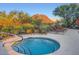 Community hot tub, framed by a fence, offering seating and stunning views of the surrounding landscape at 27000 N Alma School Pkwy # 1033, Scottsdale, AZ 85262