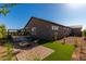 Beautiful backyard features gravel area with chairs, artificial turf and nice landscaping at 27647 N 176Th Dr, Surprise, AZ 85387