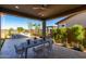 Inviting covered patio with dining area and built-in grill perfect for entertaining at 27647 N 176Th Dr, Surprise, AZ 85387
