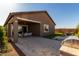 Spacious backyard including covered patio, artificial turf, built-in grill, and desert landscaping at 27647 N 176Th Dr, Surprise, AZ 85387