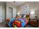 Cozy bedroom showcasing a playful comic-themed bedspread and ample closet space at 27647 N 176Th Dr, Surprise, AZ 85387