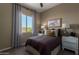 This cozy bedroom features neutral walls, a bright window, and simple decor at 27647 N 176Th Dr, Surprise, AZ 85387