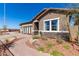 Inviting single-story home featuring well-manicured landscaping and stone accents under a bright blue sky at 27647 N 176Th Dr, Surprise, AZ 85387