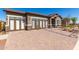 Charming single-story home boasting a stylish facade with stone accents and a paved driveway under a clear blue sky at 27647 N 176Th Dr, Surprise, AZ 85387