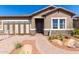 Beautiful single-story home showcasing manicured landscaping, stone accents, and a welcoming entrance at 27647 N 176Th Dr, Surprise, AZ 85387