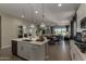 Bright open kitchen with quartz countertops, stainless appliances, a dining area, and access to the living room at 27647 N 176Th Dr, Surprise, AZ 85387