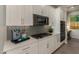Close up of a kitchen with white cabinetry, stainless steel appliances, quartz countertops, and decorative tile backsplash at 27647 N 176Th Dr, Surprise, AZ 85387