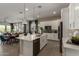 Bright open kitchen with quartz countertops, stainless appliances, a dining area, and access to the living room at 27647 N 176Th Dr, Surprise, AZ 85387