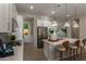 Modern kitchen showcasing white cabinetry, stainless steel appliances, quartz countertops, and decorative pendant lighting at 27647 N 176Th Dr, Surprise, AZ 85387