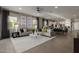 Spacious living room with stylish decor, featuring a gray sofa, modern lighting, and an open layout at 27647 N 176Th Dr, Surprise, AZ 85387