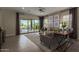 Bright living room featuring a sliding glass door to patio, stylish decor, and comfortable seating at 27647 N 176Th Dr, Surprise, AZ 85387