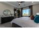 This main bedroom has a ceiling fan, an ensuite bathroom and a window for plenty of natural light at 27647 N 176Th Dr, Surprise, AZ 85387