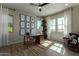 Bright and spacious home office featuring ample natural light, a modern desk, and stylish decor at 27647 N 176Th Dr, Surprise, AZ 85387