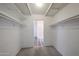 Bright walk-in closet featuring carpet flooring and basic white shelving at 2933 W Del Mar Ln, Phoenix, AZ 85053