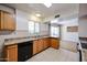 Well-lit kitchen featuring classic cabinets, laminate countertops, stainless steel sink, and tile flooring at 2933 W Del Mar Ln, Phoenix, AZ 85053