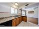 Traditional kitchen design with double sink, wood cabinets and tiled floor at 2933 W Del Mar Ln, Phoenix, AZ 85053