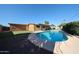 Enjoy this backyard with a refreshing pool surrounded by green grass and ample space for outdoor relaxation at 2933 W Del Mar Ln, Phoenix, AZ 85053