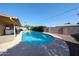 Large in-ground pool surrounded by a concrete deck and block fence at 2933 W Del Mar Ln, Phoenix, AZ 85053