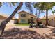 Relaxing backyard with artificial grass, desert landscaping and a covered patio with outdoor seating at 3222 E Cortez St, Phoenix, AZ 85028