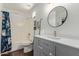 Well-lit bathroom with modern vanity, round mirror, and updated fixtures for a refreshing and clean space at 3222 E Cortez St, Phoenix, AZ 85028
