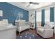 Charming Bedroom with crib, comfortable chair, and blue accent wall, ideal for a peaceful setting at 3222 E Cortez St, Phoenix, AZ 85028