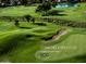 Lush green golf course featuring mature trees, sand traps, and a serene pond with a fountain at 3222 E Cortez St, Phoenix, AZ 85028