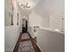 Bright hallway with hardwood floors, art, and contemporary lighting leading to other rooms at 3222 E Cortez St, Phoenix, AZ 85028