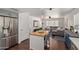 Open concept kitchen with island overlooking a spacious living room and stainless steel appliances at 3222 E Cortez St, Phoenix, AZ 85028