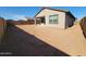 Large backyard featuring a covered patio, privacy fence, and plenty of space to add personalized landscaping at 328 S San Christo Ln, Casa Grande, AZ 85194