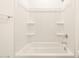 Clean white bathroom featuring a shower with a bathtub, shelves, and modern fixtures at 328 S San Christo Ln, Casa Grande, AZ 85194