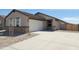 Inviting single-story home featuring a two-car garage, stone accents, and a well-maintained concrete driveway at 328 S San Christo Ln, Casa Grande, AZ 85194