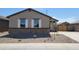 Attractive single-story home featuring stone veneer, white shutters, a desert-scape yard, and a concrete sidewalk at 328 S San Christo Ln, Casa Grande, AZ 85194