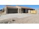 Single-story home with a tile roof, desert landscaping, and a two-car garage at 329 S San Christo Ln, Casa Grande, AZ 85194