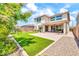 Well manicured backyard that boasts artificial turf, mature foliage and desert landscaping at 3417 E Los Gatos Dr, Phoenix, AZ 85050