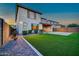Beautifully landscaped backyard with artificial turf and desert landscaping at 3417 E Los Gatos Dr, Phoenix, AZ 85050