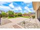 Landscaped backyard with stone, artificial turf, desert foliage and a patio at 3417 E Los Gatos Dr, Phoenix, AZ 85050