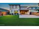 Beautiful backyard featuring artificial grass, a covered patio, and well-maintained landscaping at 3417 E Los Gatos Dr, Phoenix, AZ 85050