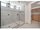 Modern bathroom featuring a glass enclosed shower with tiled walls and a view into a walk in closet at 3417 E Los Gatos Dr, Phoenix, AZ 85050