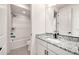 Well-lit bathroom includes a shower-tub combination and a vanity with a granite countertop at 3417 E Los Gatos Dr, Phoenix, AZ 85050