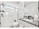 Bright bathroom boasts a walk-in shower with glass enclosure and a vanity with a granite countertop at 3417 E Los Gatos Dr, Phoenix, AZ 85050
