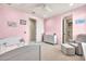 ' bedroom is decorated with pastel pink walls, complemented by soft furnishings and cozy furniture at 3417 E Los Gatos Dr, Phoenix, AZ 85050