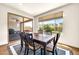 Cozy dining area with a wood table, chairs, and a sliding glass door leading to the backyard patio at 3417 E Los Gatos Dr, Phoenix, AZ 85050