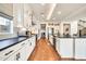 Spacious kitchen featuring white cabinets, black countertops, and hardwood floors, offering an open and inviting space at 3417 E Los Gatos Dr, Phoenix, AZ 85050