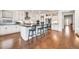 Open-concept kitchen with white cabinets, black countertops, large island, and stainless-steel appliances at 3417 E Los Gatos Dr, Phoenix, AZ 85050