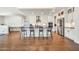 Open-concept kitchen featuring a large island with seating, white cabinetry, and modern stainless-steel appliances at 3417 E Los Gatos Dr, Phoenix, AZ 85050