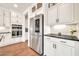 Modern kitchen featuring white cabinetry, stainless steel appliances, granite countertops, and hardwood floors at 3417 E Los Gatos Dr, Phoenix, AZ 85050