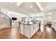 Bright and open living space featuring wood floors, island seating and seamless integration with kitchen at 3417 E Los Gatos Dr, Phoenix, AZ 85050