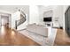 Open-concept living room with soaring ceilings, modern staircase, and a fireplace with television at 3417 E Los Gatos Dr, Phoenix, AZ 85050